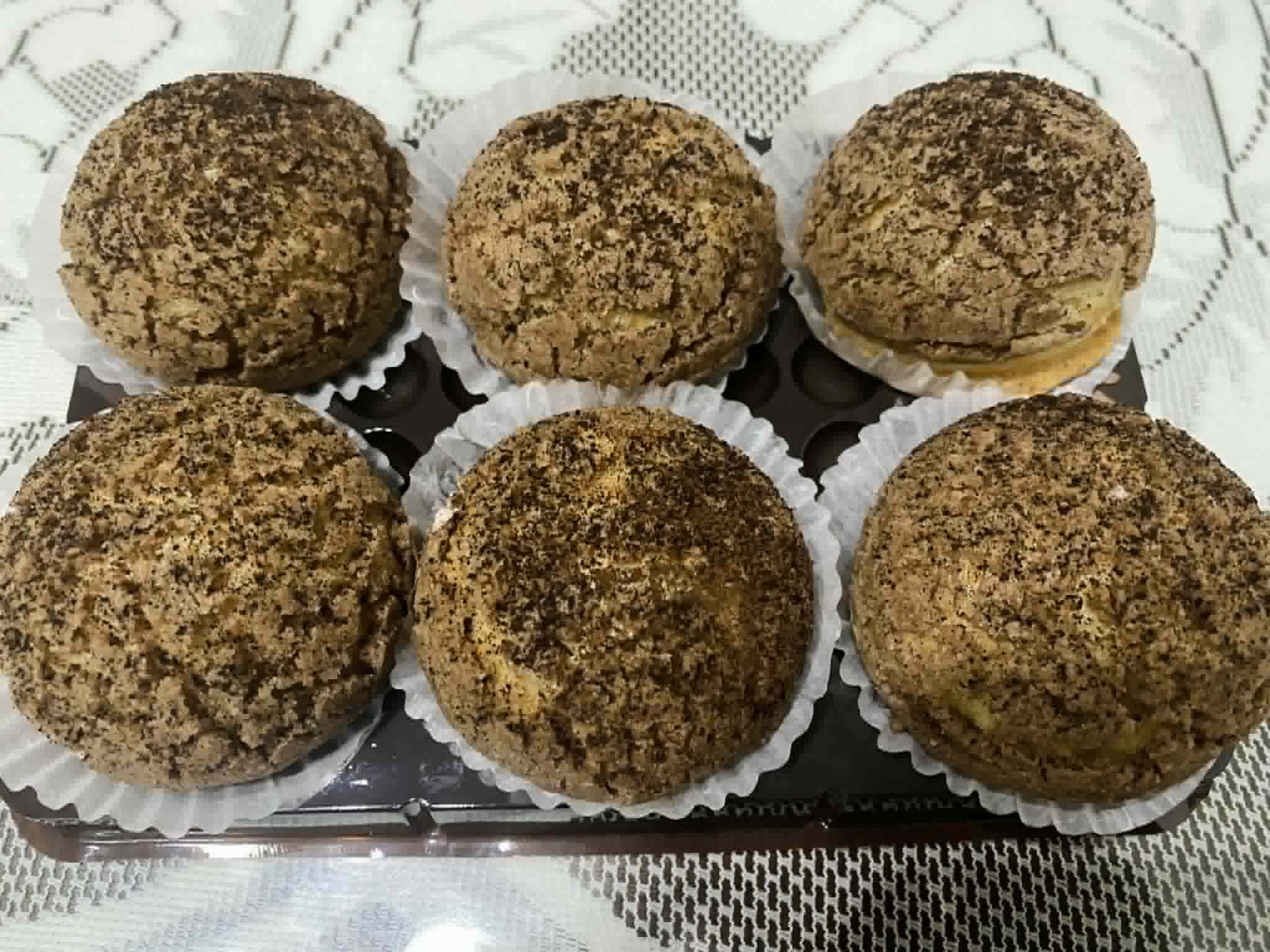 Six Chocolate cream puffs in a tray